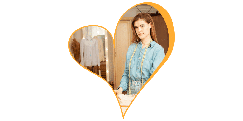 Woman in a light blue shirt standing in a boutique, shown inside an orange heart shape