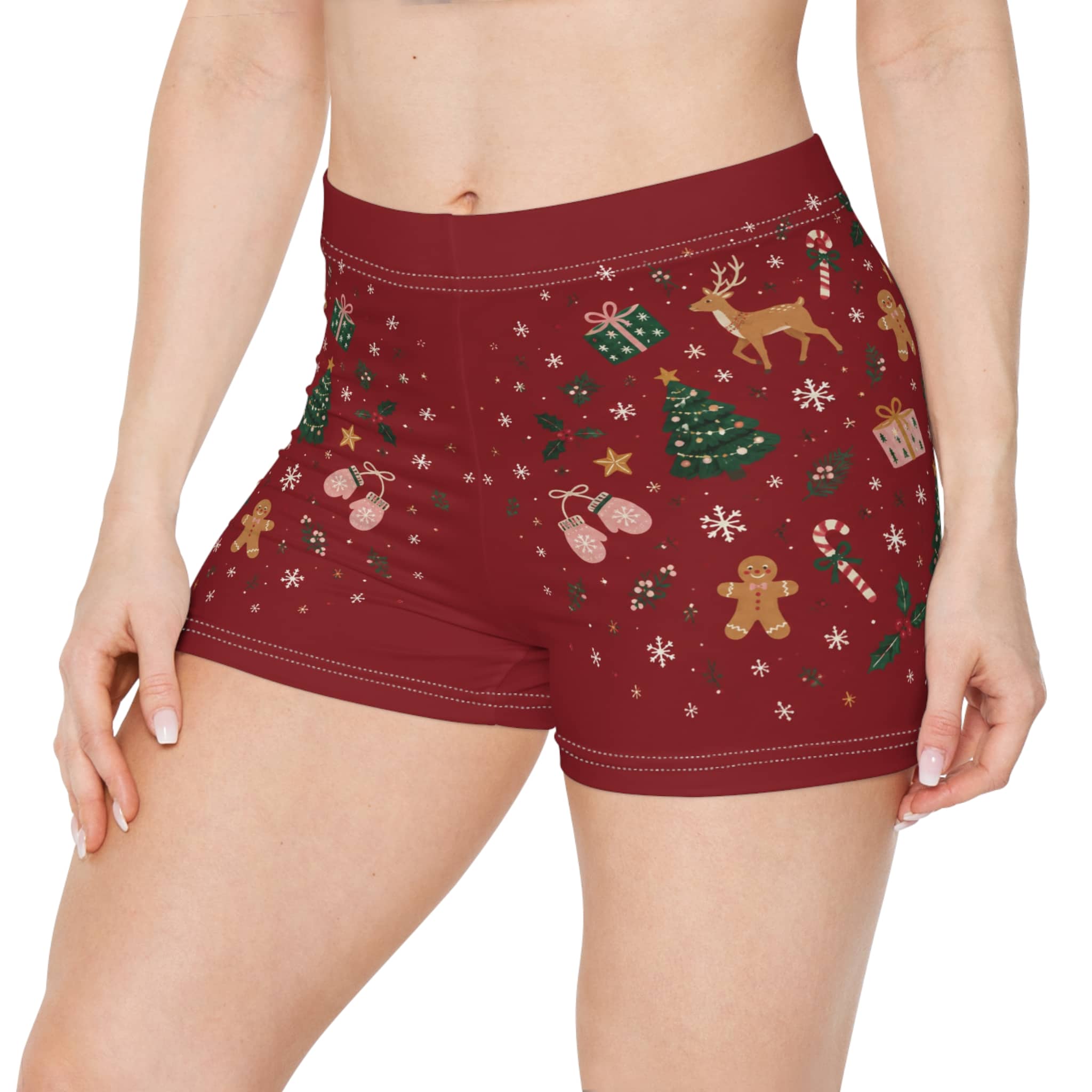 Christmas women's shorts in deep red with reindeer, trees and gingerbread motifs, shown on a model