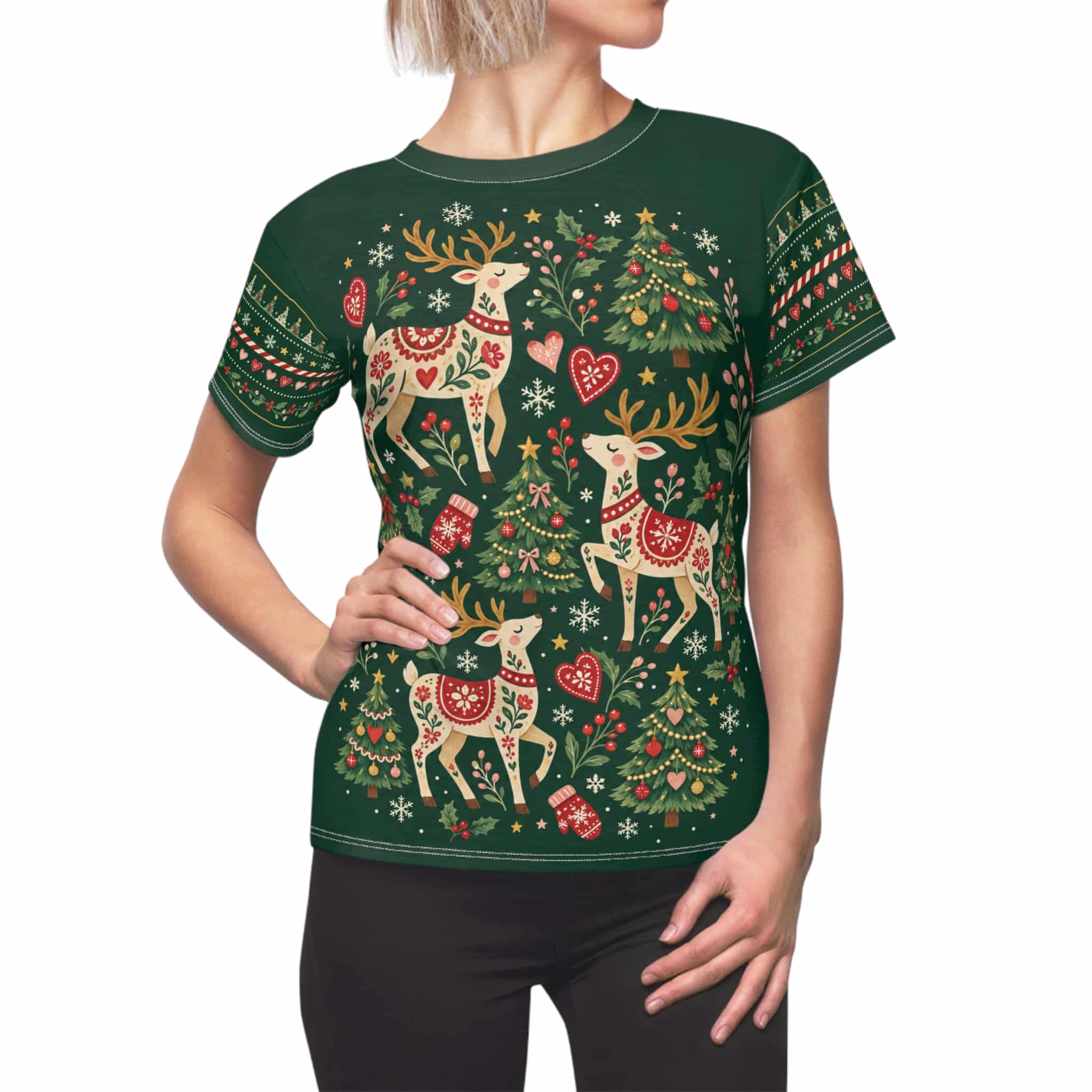 Green women's Christmas reindeer tee with folk-style reindeer and fir trees, shown on a model